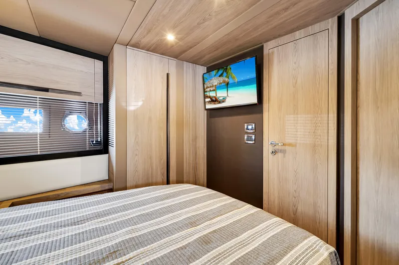 Slide: The Image of Luxurious bedroom interior of 2016 Azimut 55S yacht with modern wood finishes and scenic artwork. - 49