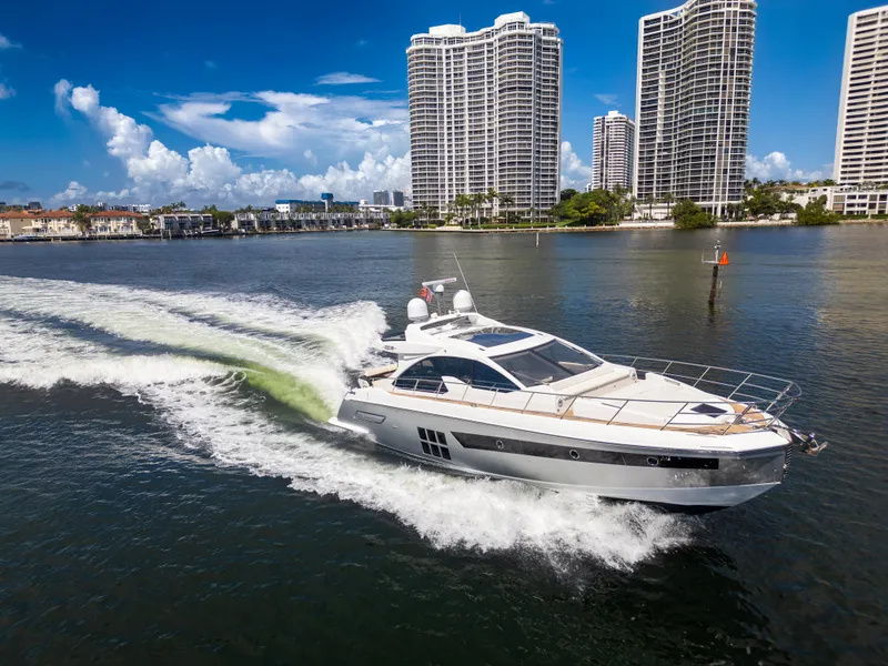 Slide: The Image of 2016 Azimut 55S yacht cruising near modern high-rise buildings on a sunny day. - 6