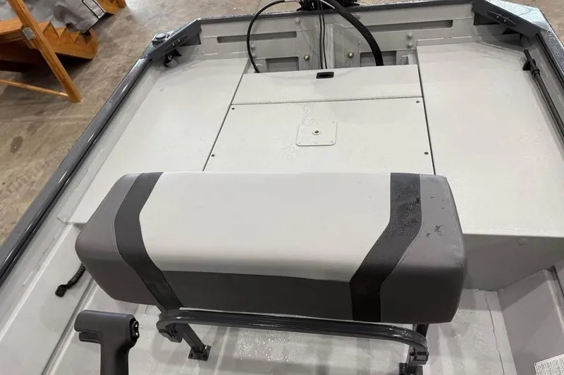 Slide: The Image of 2026 Crestliner 1660 Retriever FCC boat interior with seating and steering console. - 11