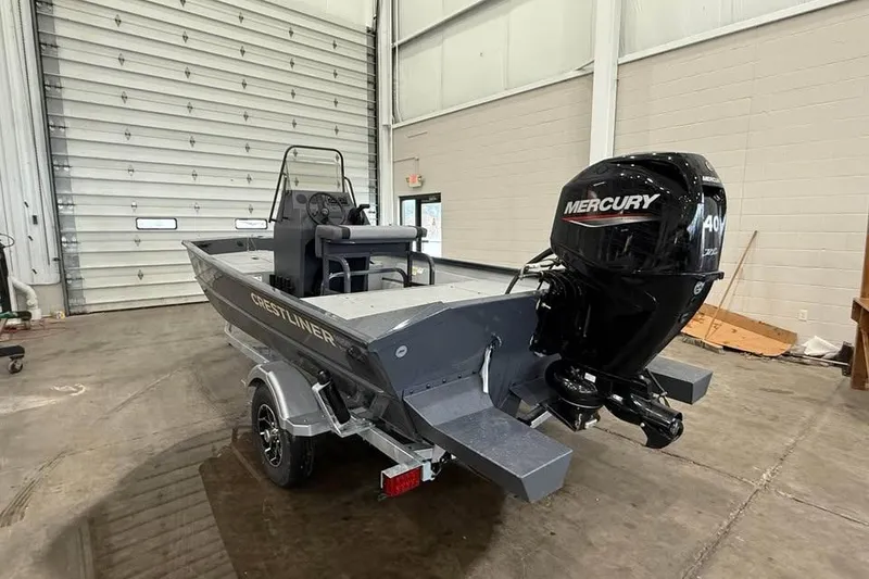 Slide: The Image of 2026 Crestliner 1660 Retriever FCC boat with Mercury 40HP engine in a garage. - 4