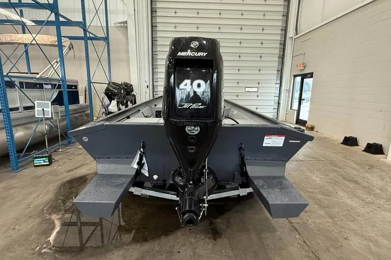 Slide: The Image of 2026 Crestliner 1660 Retriever FCC boat with Mercury 40 HP engine in a warehouse. - 6