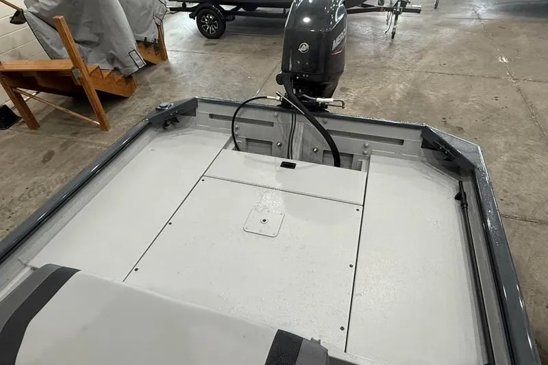 Slide: The Image of 2026 Crestliner 1660 Retriever FCC boat interior with motor in a showroom. - 7