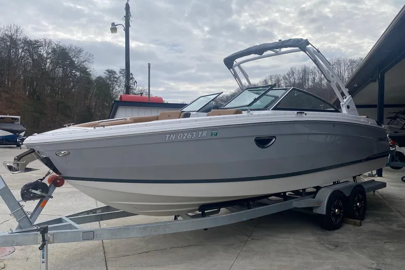 Slide: The Image of 2022 Cobalt R8 boat on trailer, parked outdoors, with overcast sky background. - 1
