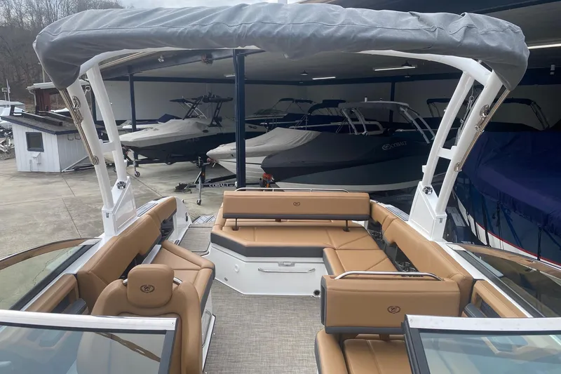 Slide: The Image of 2022 Cobalt R8 boat with tan seating and covered deck in showroom. - 13