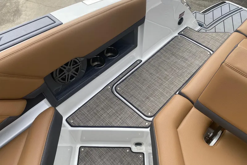 Slide: The Image of 2022 Cobalt R8 boat interior with tan seats, speaker, and cup holders. - 14