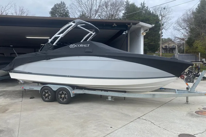 Slide: The Image of 2022 Cobalt R8 boat on trailer with protective cover, parked outdoors. - 4