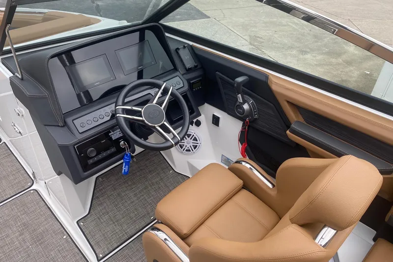 Slide: The Image of 2022 Cobalt R8 boat cockpit with modern steering wheel and tan leather seat. - 7
