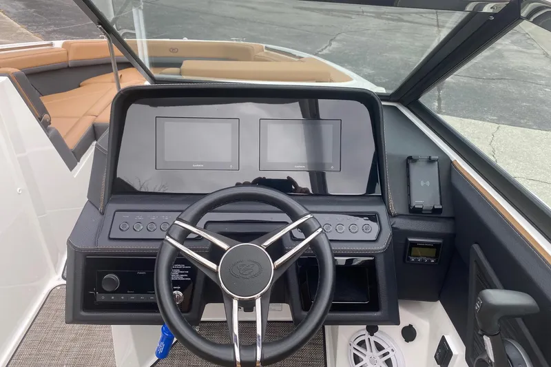 Slide: The Image of 2022 Cobalt R8 boat dashboard with dual Garmin displays and steering wheel. - 8