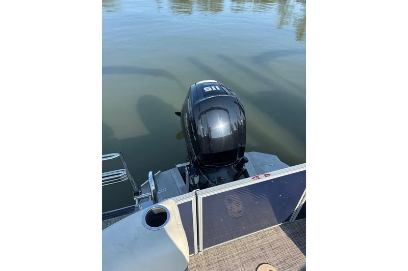 Slide: The Image of 2023 Cypress Cay Seabreeze 232 boat with outboard motor on calm water. - 10