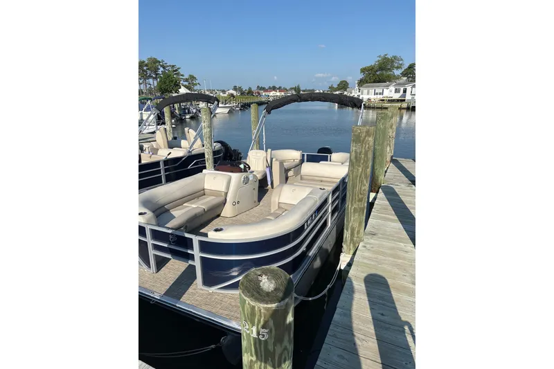 Slide: The Image of 2023 Cypress Cay Seabreeze 232 pontoon boat docked by a wooden pier. - 4
