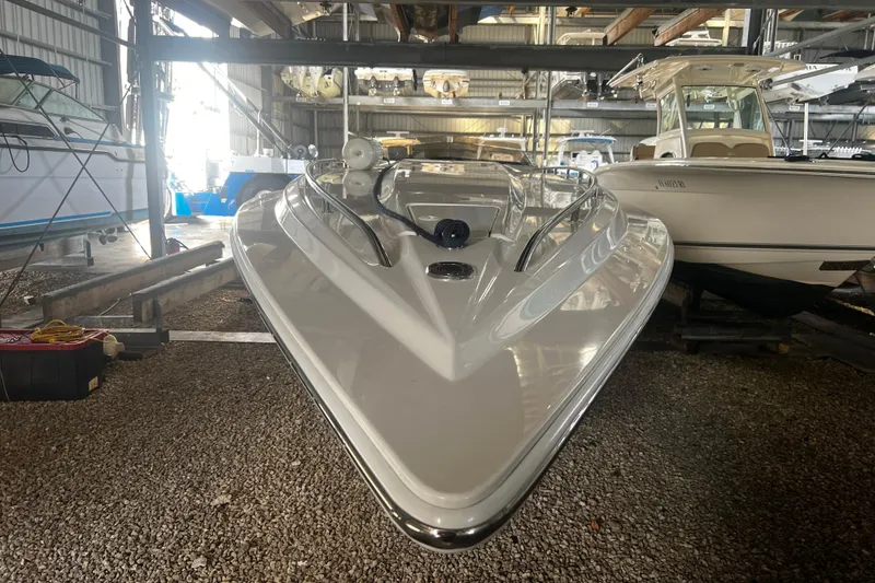 Slide: The Image of 2009 Fountain 42 Executioner speedboat in storage, front view, surrounded by other boats. - 10