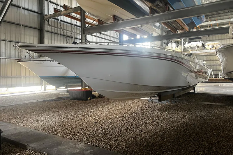 Slide: The Image of 2009 Fountain 42 Executioner boat in storage, side view, indoors. - 13