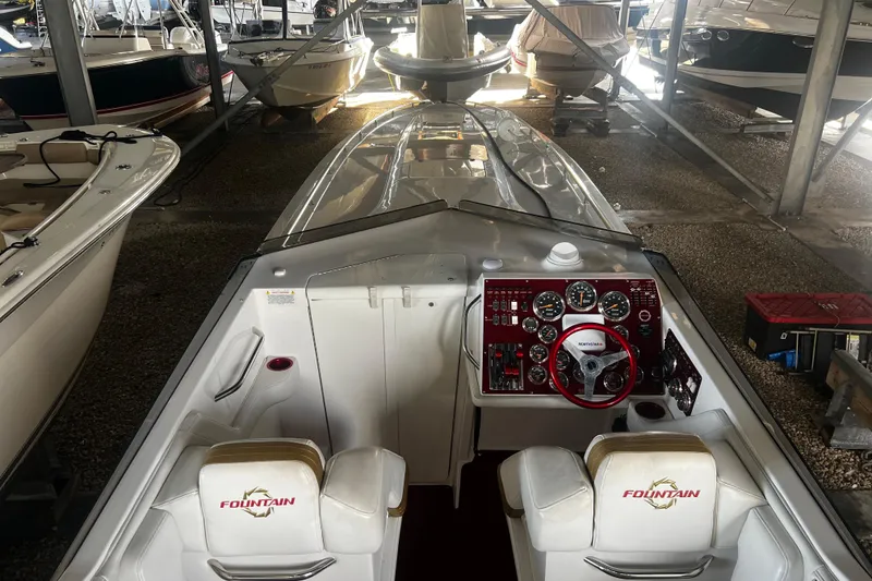 Slide: The Image of 2009 Fountain 42 Executioner boat interior with steering wheel and dashboard in storage. - 17