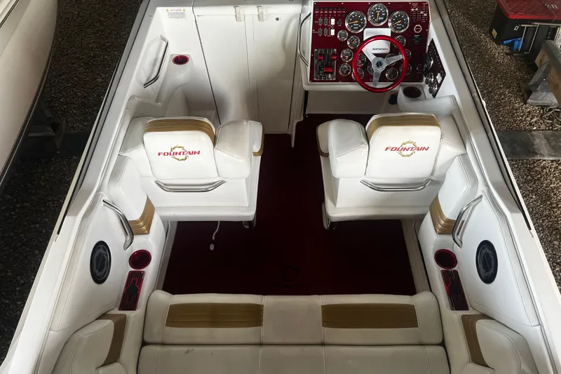 Slide: The Image of 2009 Fountain 42 Executioner boat interior with white seating and red dashboard. - 18