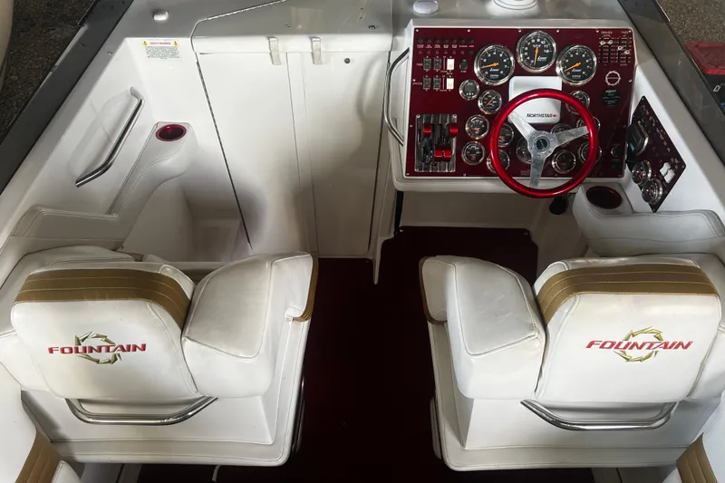 Slide: The Image of 2009 Fountain 42 Executioner boat cockpit with dual seats and detailed control panel. - 20