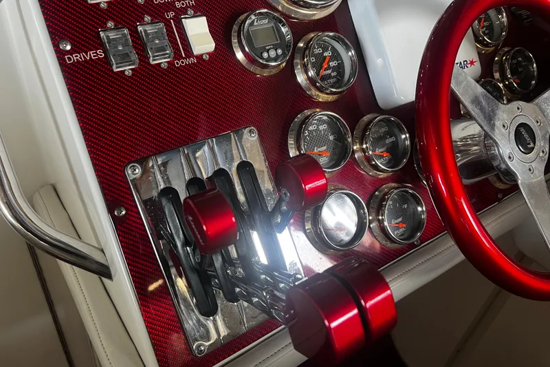 Slide: The Image of Control panel of a 2009 Fountain 42 Executioner boat with red accents and gauges. - 24