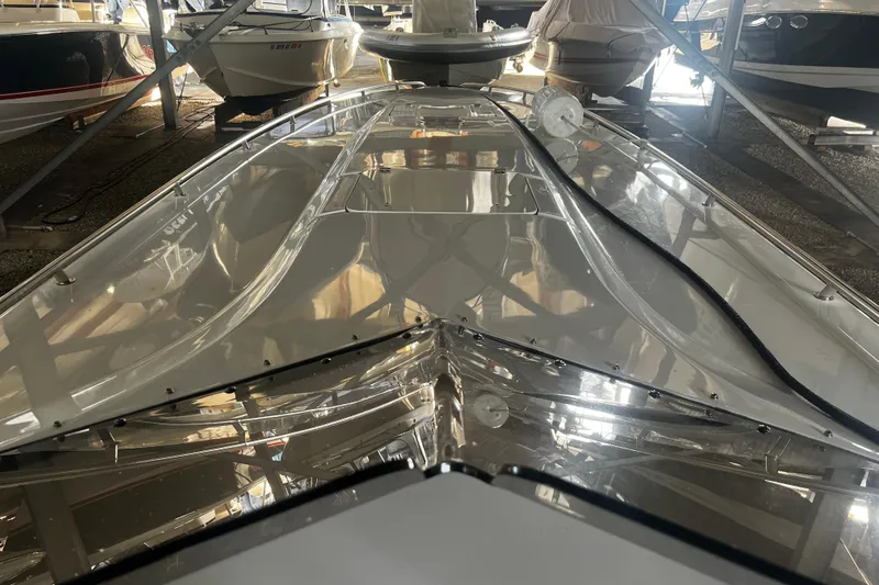 Slide: The Image of 2009 Fountain 42 Executioner boat in storage, showcasing sleek design and reflective surface. - 30