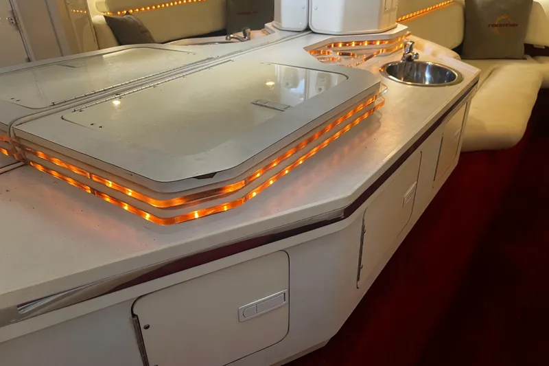 Slide: The Image of 2009 Fountain 42 Executioner boat interior with illuminated countertop and sink. - 38