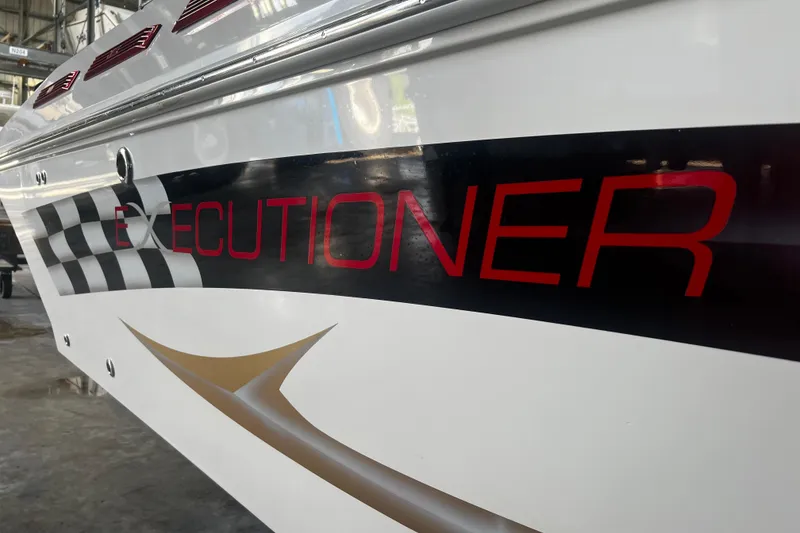 Slide: The Image of 2009 Fountain 42 Executioner boat with bold red lettering and checkered flag design. - 4