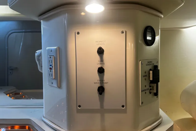 Slide: The Image of Control panel inside 2009 Fountain 42 Executioner boat, featuring light and water pump switches. - 40