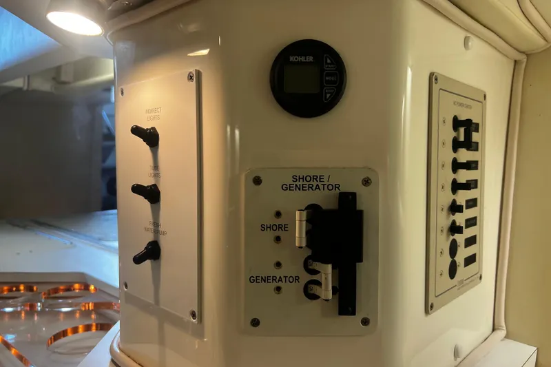 Slide: The Image of 2009 Fountain 42 Executioner control panel with switches and generator settings. - 42