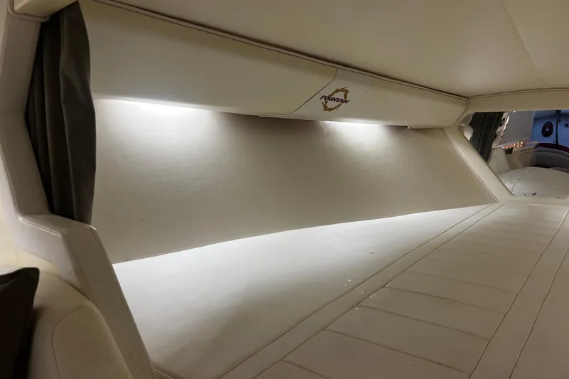 Slide: The Image of Interior cabin of 2009 Fountain 42 Executioner boat, featuring sleek white design and ambient lighting. - 46