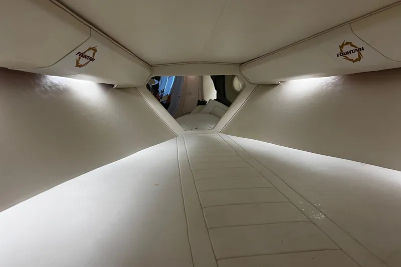 Slide: The Image of Interior cabin of 2009 Fountain 42 Executioner boat, featuring sleek white upholstery. - 47