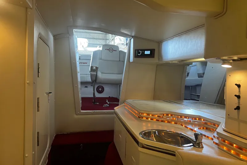Slide: The Image of Interior of 2009 Fountain 42 Executioner boat with kitchenette and seating area. - 56