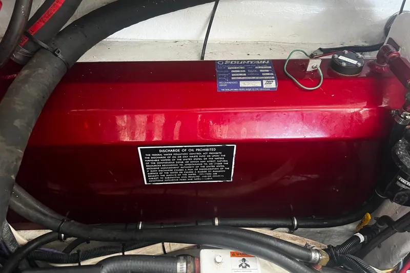 Slide: The Image of Engine compartment of a 2009 Fountain 42 Executioner boat with oil discharge warning. - 73