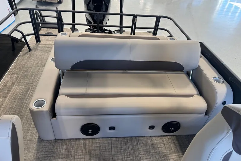 Slide: The Image of 2026 Bentley Pontoons Legacy 243 Swingback interior with beige seating and cup holders. - 6