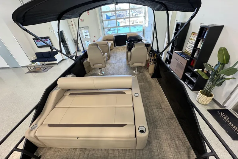Slide: The Image of 2026 Bentley Pontoons Legacy 243 Swingback interior with beige seating and canopy. - 8