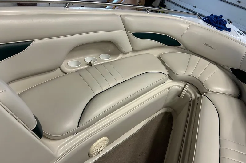Slide: The Image of 2002 Crownline 230 BR boat interior with beige seating and cup holders. - 16