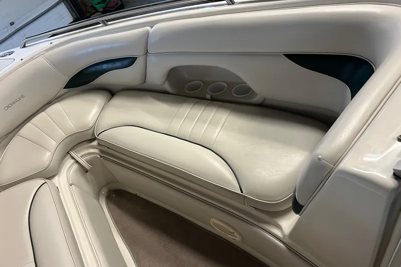 Slide: The Image of 2002 Crownline 230 BR boat interior with beige leather seating and cup holders. - 17