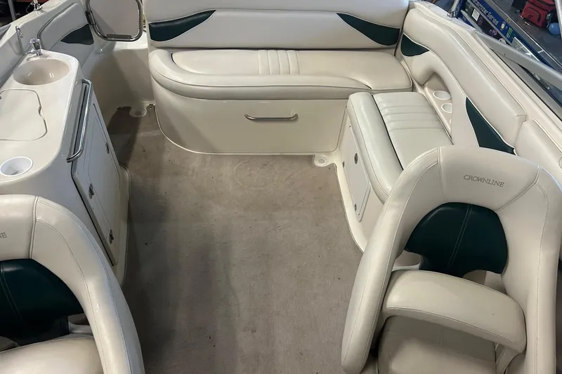 Slide: The Image of Interior of a 2002 Crownline 230 BR boat with white and green seating. - 19