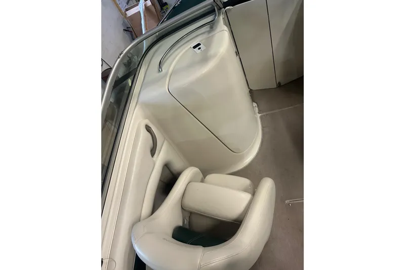 Slide: The Image of Interior of 2002 Crownline 230 BR boat, featuring white seating and sleek design. - 21