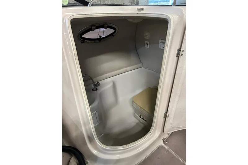 Slide: The Image of 2002 Crownline 230 BR boat interior cabin with compact toilet and sink. - 25