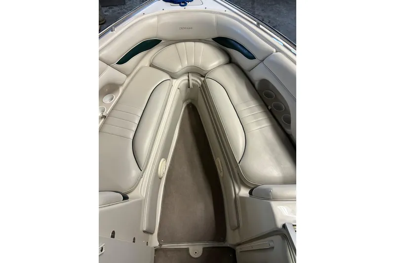 Slide: The Image of 2002 Crownline 230 BR boat interior with beige seating and cup holders. - 29