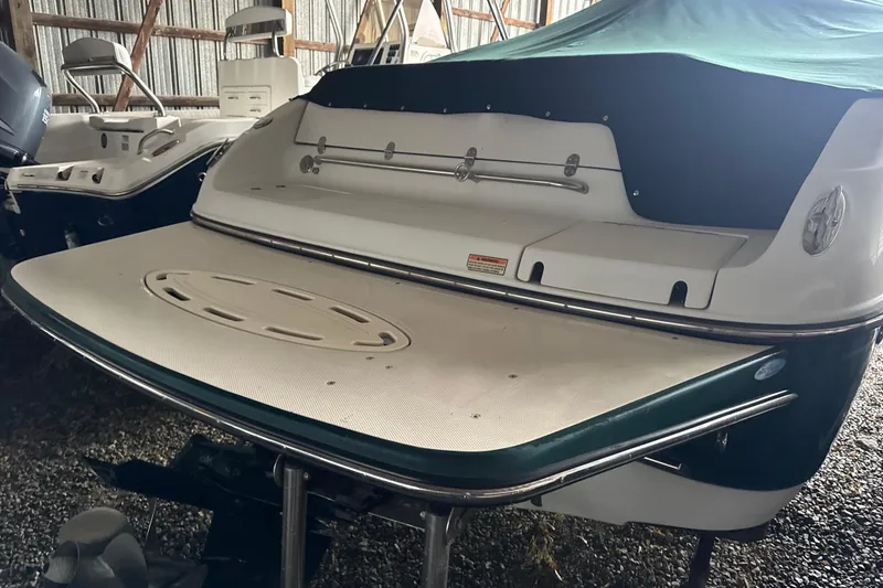 Slide: The Image of 2002 Crownline 230 BR boat with covered deck in storage. - 3