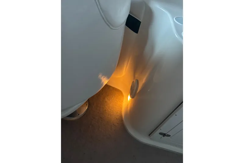 Slide: The Image of Interior lighting of a 2002 Crownline 230 BR boat, highlighting seating and floor area. - 42