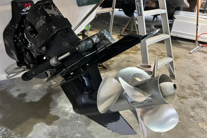 Slide: The Image of 2002 Crownline 230 BR boat propeller and drive system in a garage setting. - 6