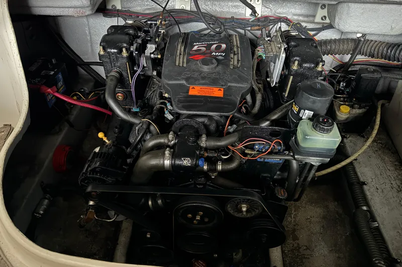 Slide: The Image of Engine compartment of a 2002 Crownline 230 BR boat, featuring a MerCruiser 5.0 MPI engine. - 8