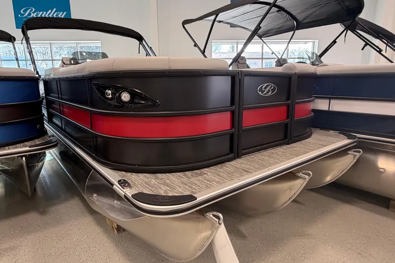The Image of 2026 Bentley Pontoons Legacy 243 Swingback, sleek design with red and black accents, in showroom. - 0