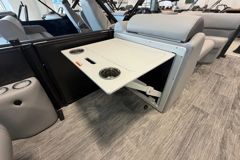 Slide: The Image of 2026 Bentley Pontoons Legacy 243 Swingback interior with fold-out table and cup holders. - 14