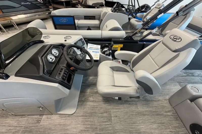 Slide: The Image of 2026 Bentley Pontoons Legacy 243 Swingback interior with steering console and captain's chair. - 8