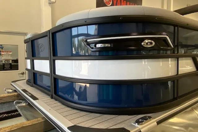 Slide: The Image of 2026 Bentley Pontoons Elite 223 Swingback, sleek blue and white design, showcased indoors. - 3