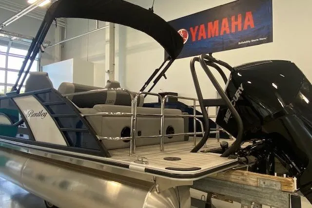 Slide: The Image of 2026 Bentley Pontoons Elite 223 Swingback with Mercury engine in showroom. - 4