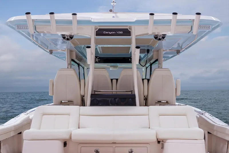 Slide: The Image of 2022 Grady-White Canyon 456 boat with four engines docked by waterfront buildings. - 11