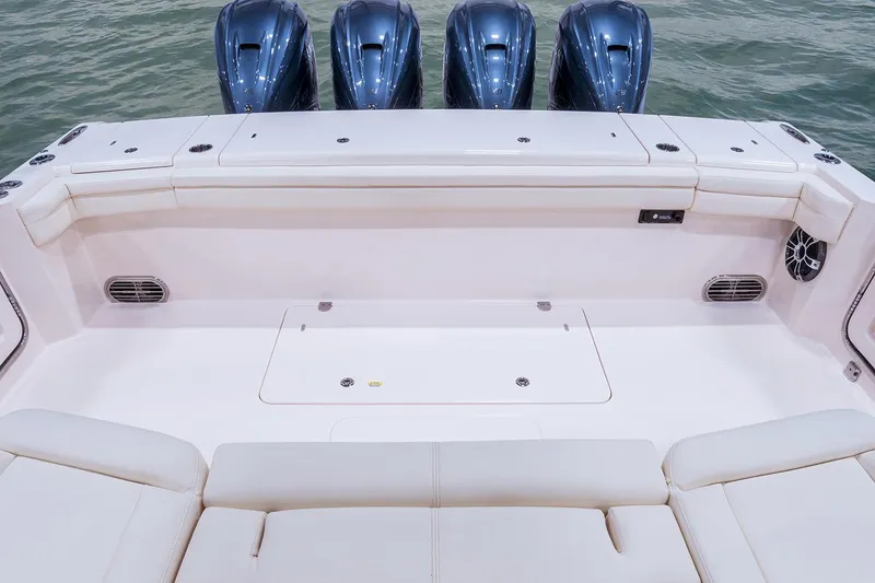 Slide: The Image of 2022 Grady-White Canyon 456 boat interior with spacious seating and multiple outboard engines. - 13
