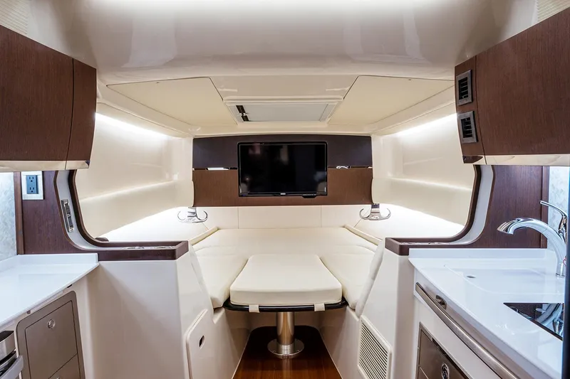 Slide: The Image of 2022 Grady-White Canyon 456 boat docked in a marina with cityscape background. - 14