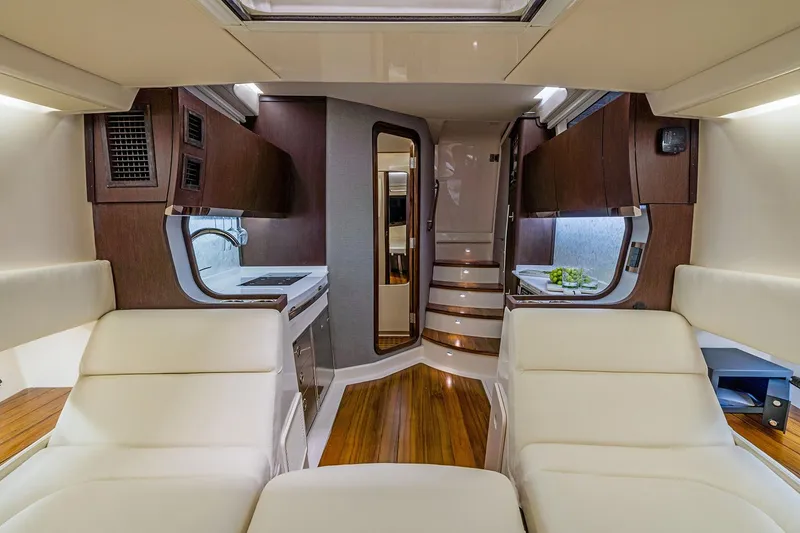 Slide: The Image of 2022 Grady-White Canyon 456 boat with spacious deck and seating, docked by the water. - 15